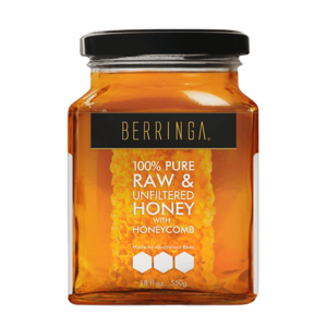 jar of pure raw and unfiltered honey with honeycomb
